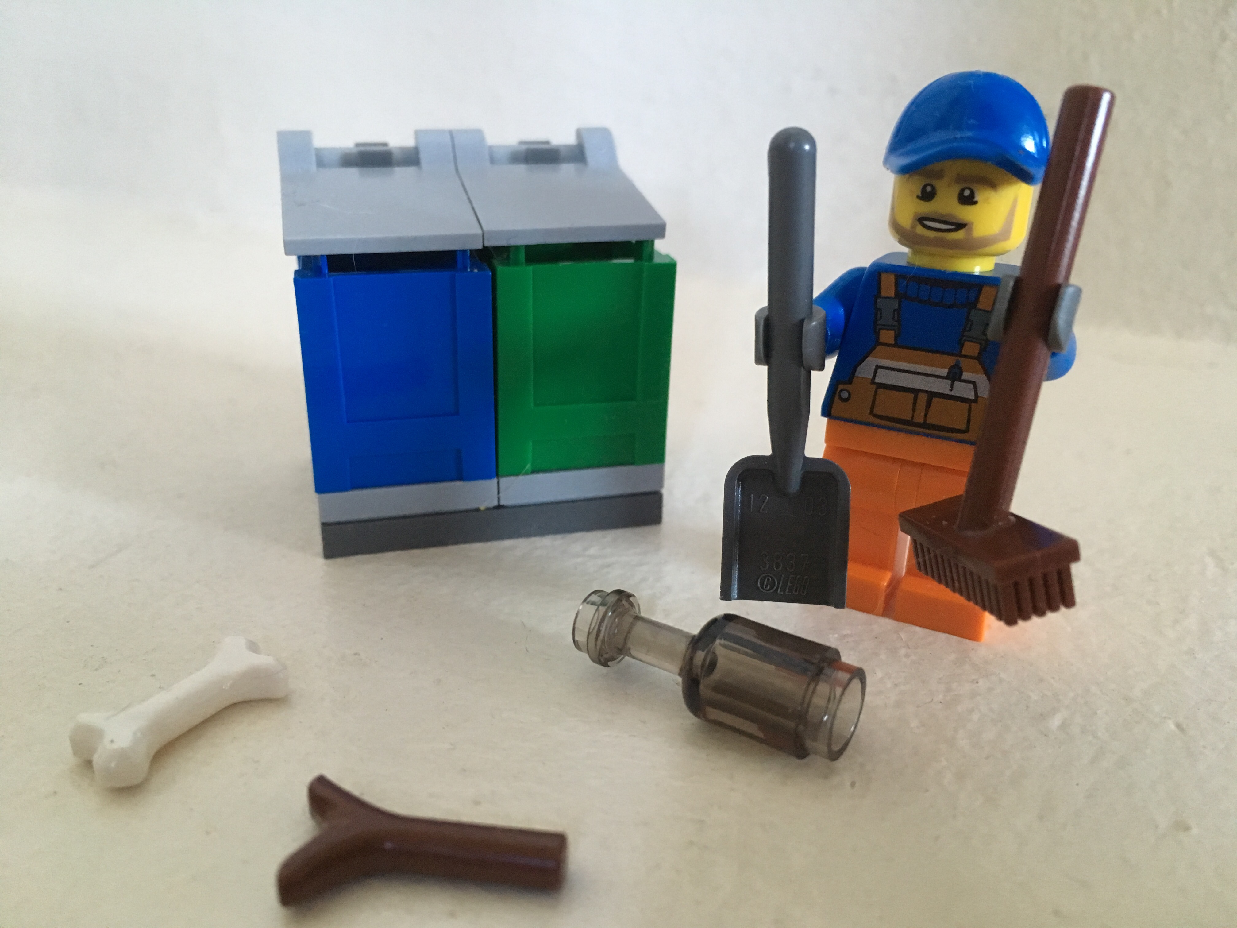 Image of LEGO Garbageman Minifigure with rubbish and trashcans