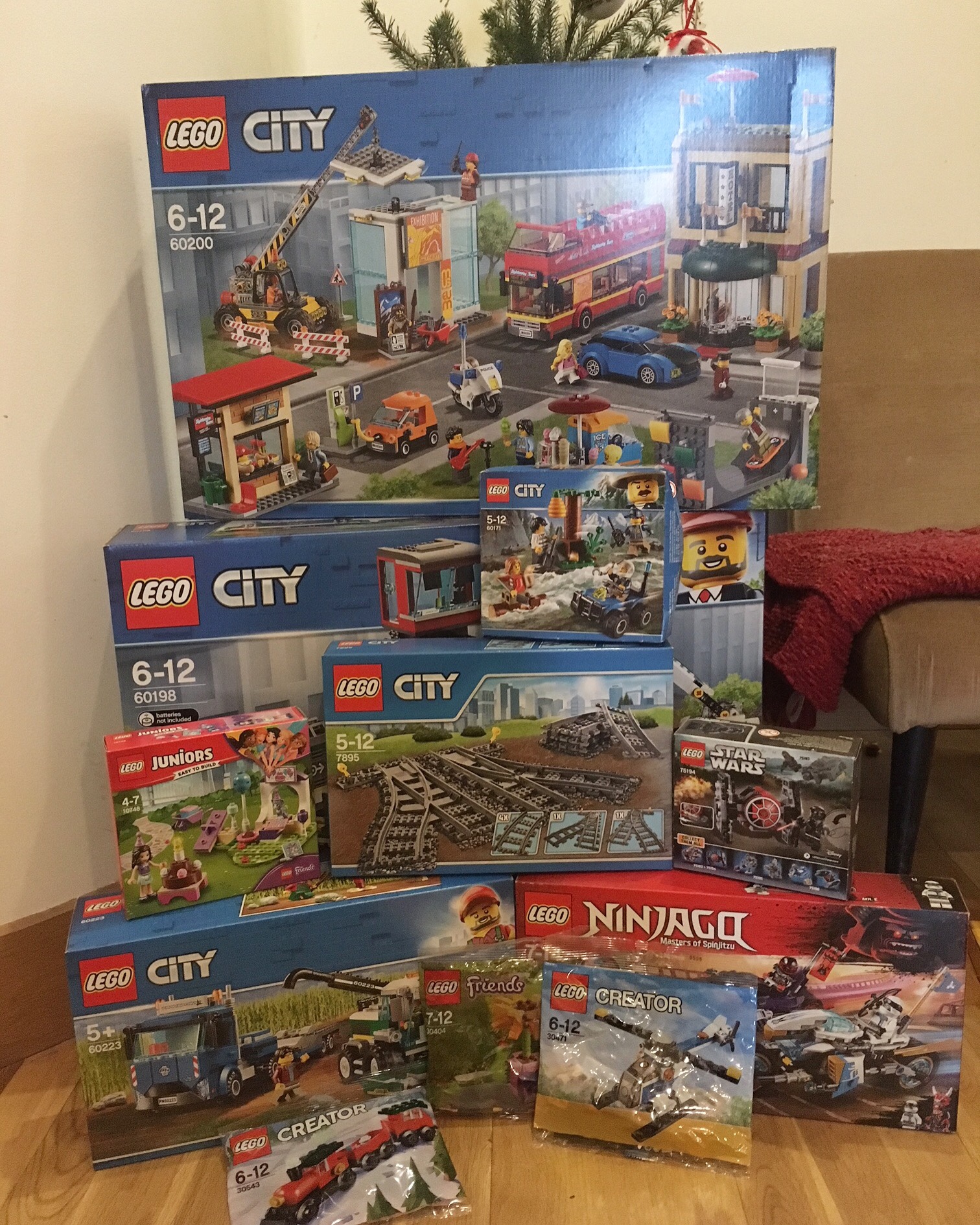 Lego sets piled under Christmas tree 